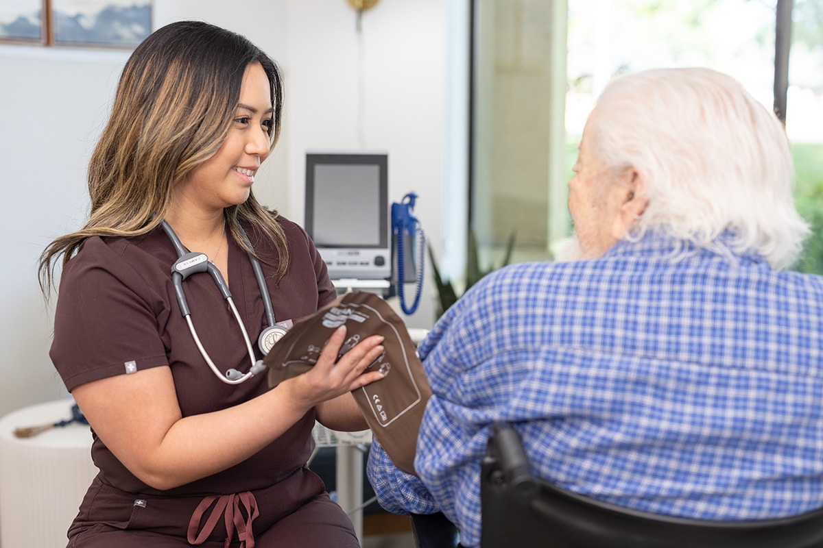 A nurse checking a man's. blood pressure at Sunnyvale Gardens