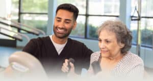 A physical therapist working with an elderly woman at Sunnyvale Gardens